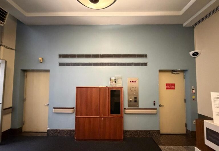 Renovated commercial corridor with new wall finishes and handrail | United City Construction