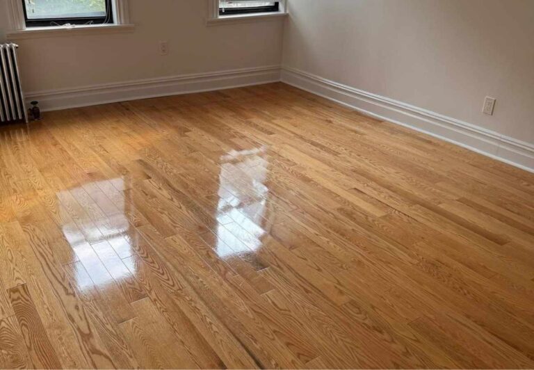 Refinished hardwood floor in a renovated room | United City Construction