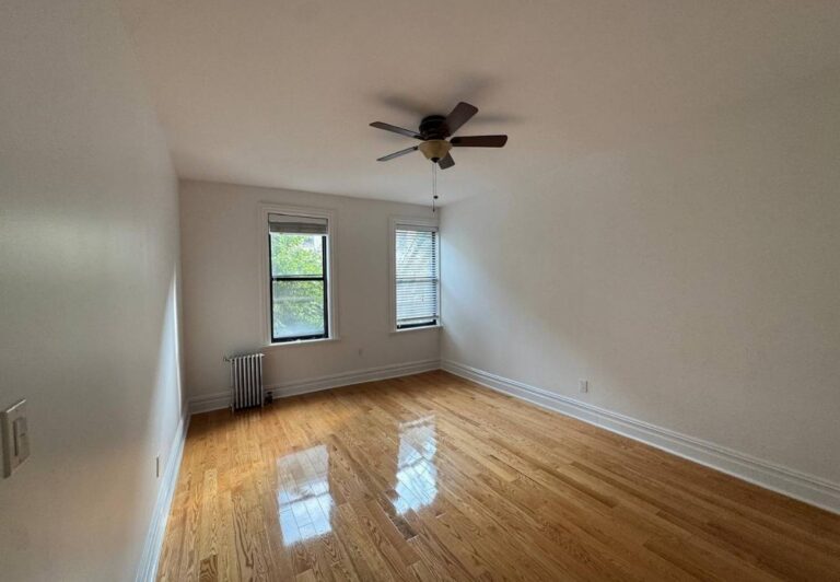 Renovated room with refinished hardwood floors and fresh paint | United City Construction