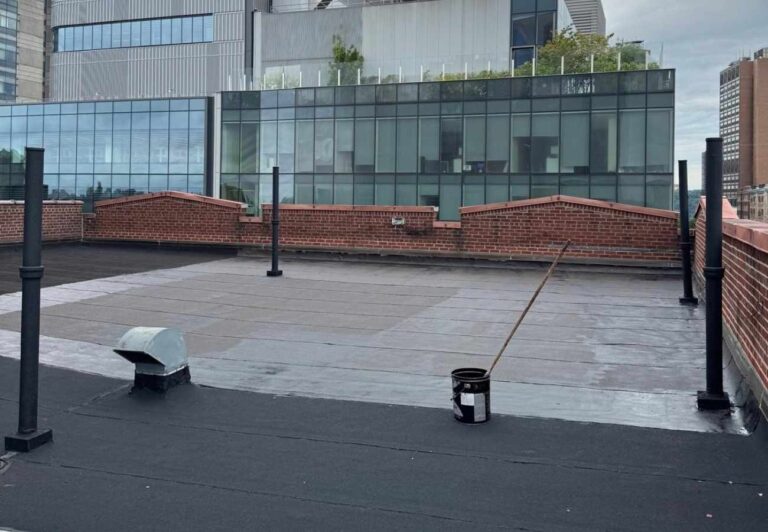 Flat roof replacement with brick parapet on a New York City building | United City Construction