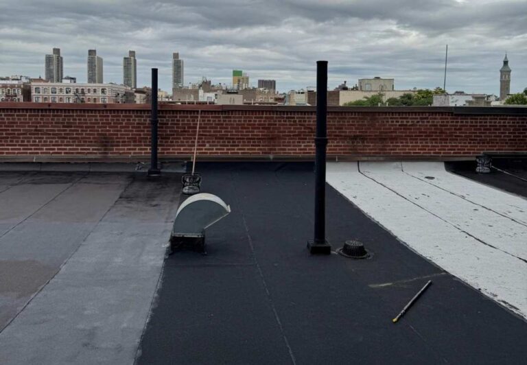 New flat roof installation on a NYC building with brick parapet | United City Construction